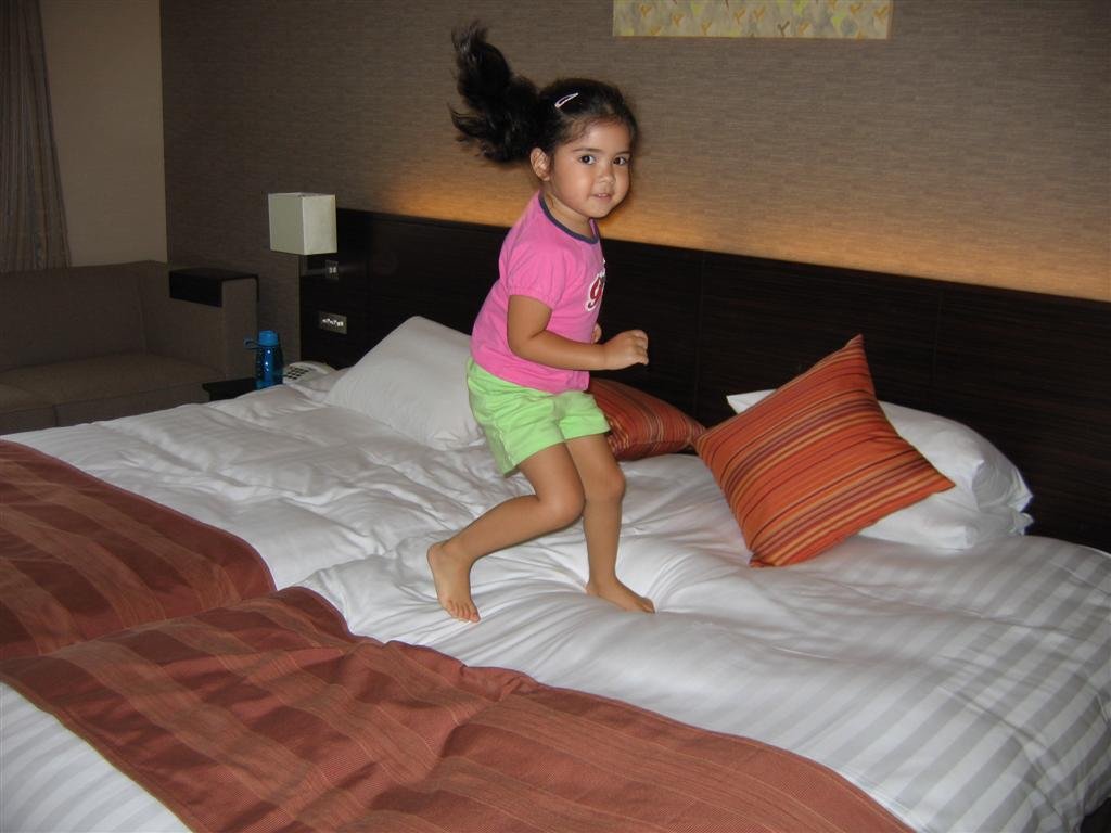 allycelebratesherfirstnightintokyobyplayingonthebed.jpg